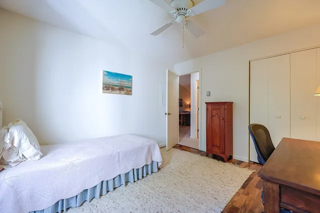 a bedroom with a bed a desk and chair