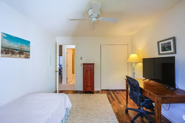 a bedroom with furniture and a mirror