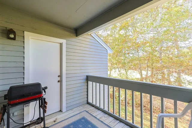 a view of a balcony with chair and wooden floor