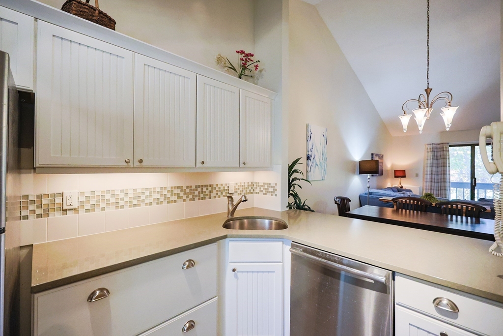 78 Eaton Lane, Unit 78 Brewster, MA 02631 - Photo 3 of 41 a kitchen with a sink and cabinets