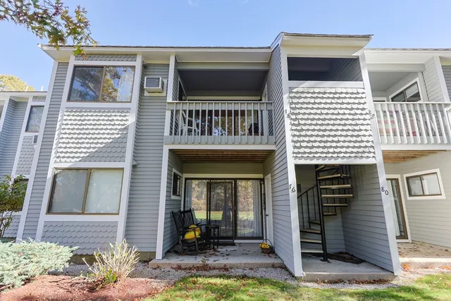 a view of a house with a yard and tree s