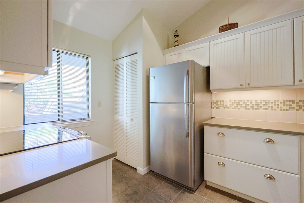 78 Eaton Lane, Unit 78 Brewster, MA 02631 - Photo 4 of 41 a kitchen with cabinets and stainless steel appliances
