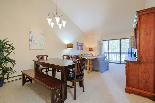 a view of a dining room with furniture and window