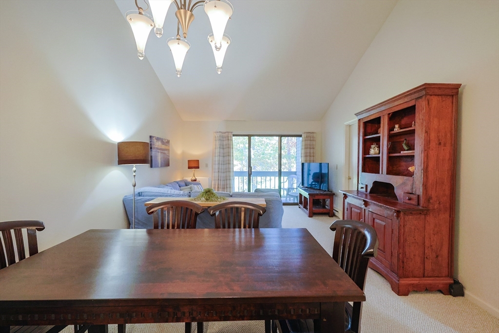 78 Eaton Lane, Unit 78 Brewster, MA 02631 - Photo 9 of 41 a view of a dining room with furniture and chandelier