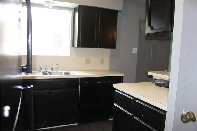 a utility room with cabinets washer and dryer