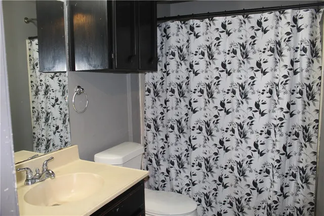 a bathroom with a sink toilet and shower