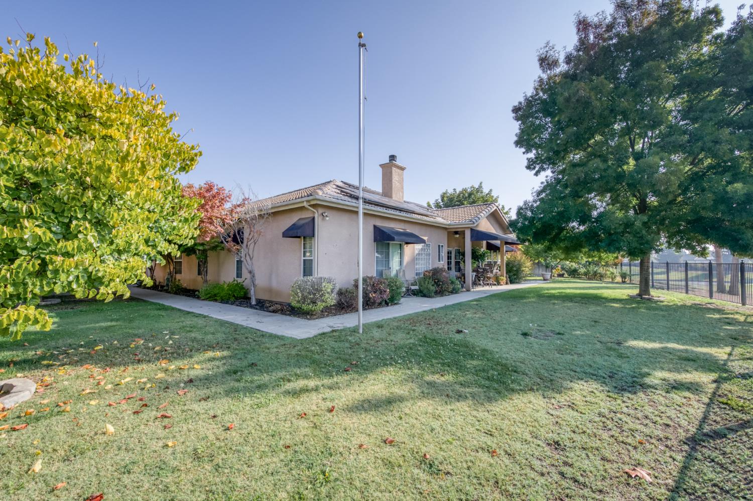7360 Edgewater Street Chowchilla, CA 93610 - Photo 11 of 44 a front view of a house with a yard