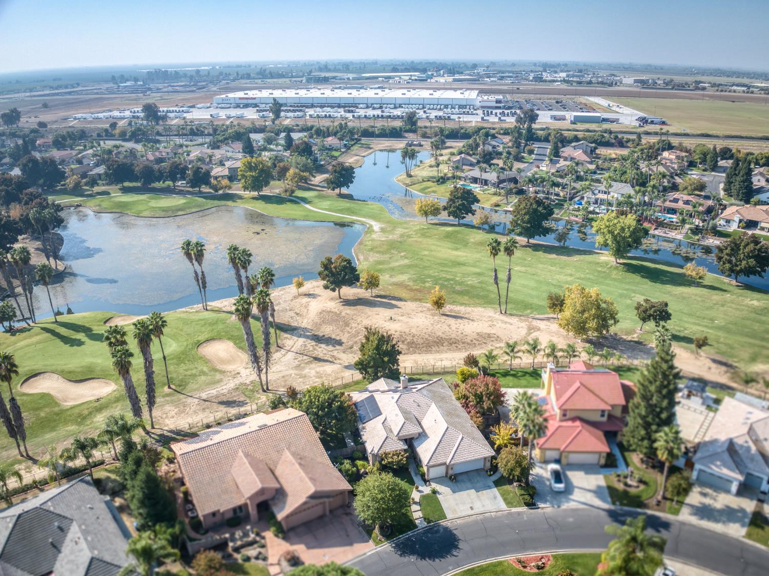 7360 Edgewater Street Chowchilla, CA 93610 - Photo 14 of 44 an aerial view of residential houses with outdoor space and lake view
