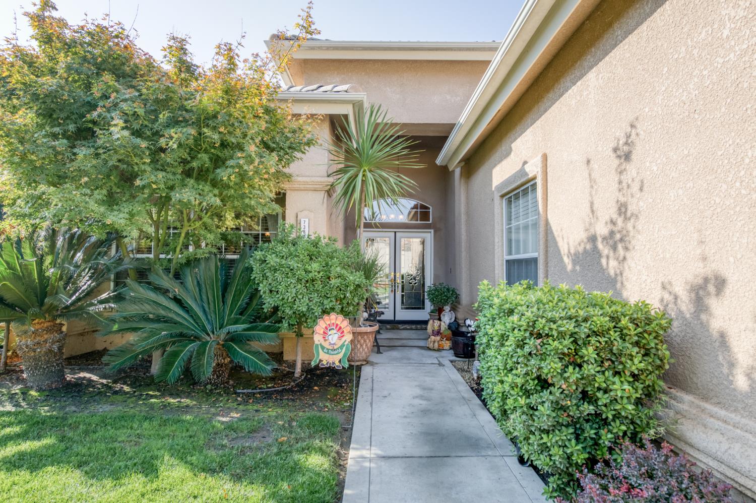 7360 Edgewater Street Chowchilla, CA 93610 - Photo 17 of 44 a view of a house with a backyard and sitting area