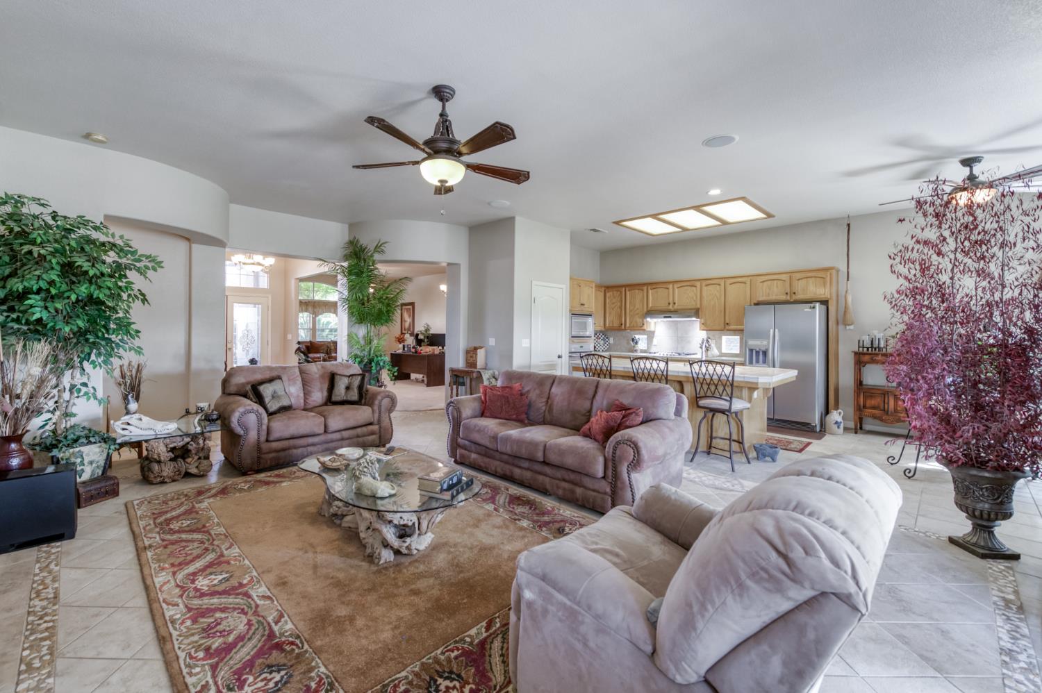 7360 Edgewater Street Chowchilla, CA 93610 - Photo 20 of 44 a living room with furniture a chandelier and a large mirror