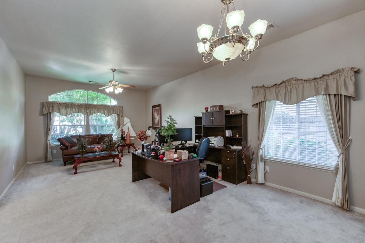 7360 Edgewater Street Chowchilla, CA 93610 - Photo 27 of 44 a living room with furniture and a large window