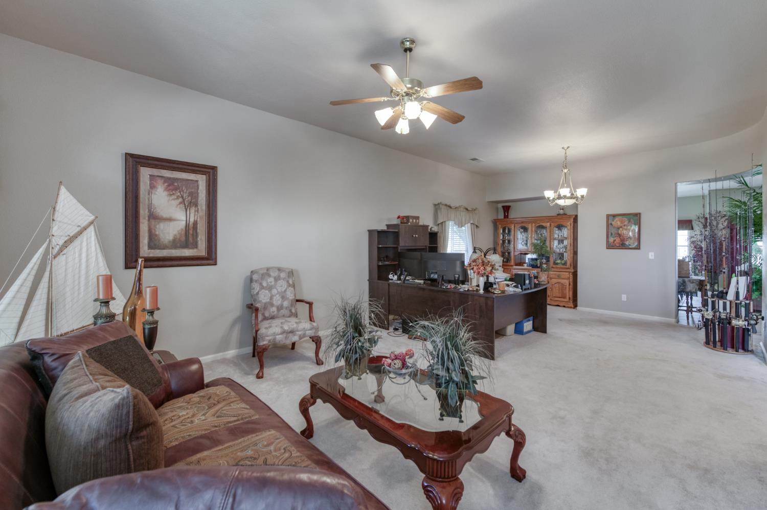 7360 Edgewater Street Chowchilla, CA 93610 - Photo 28 of 44 a living room with furniture and a chandelier