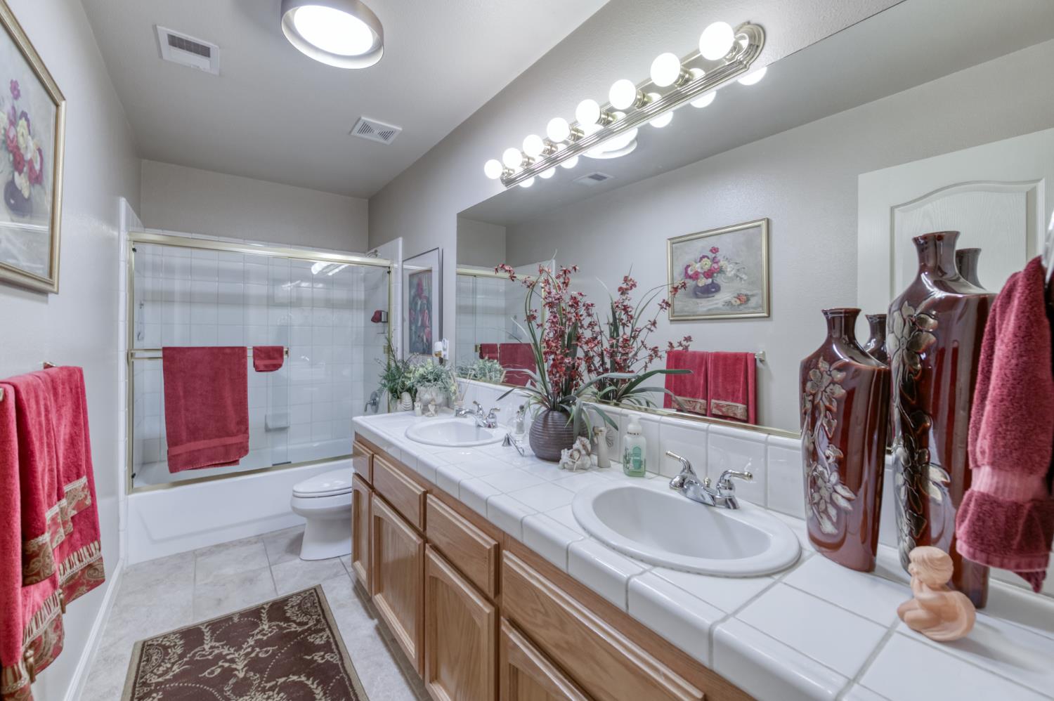 7360 Edgewater Street Chowchilla, CA 93610 - Photo 29 of 44 a bathroom with a double vanity sink and a mirror