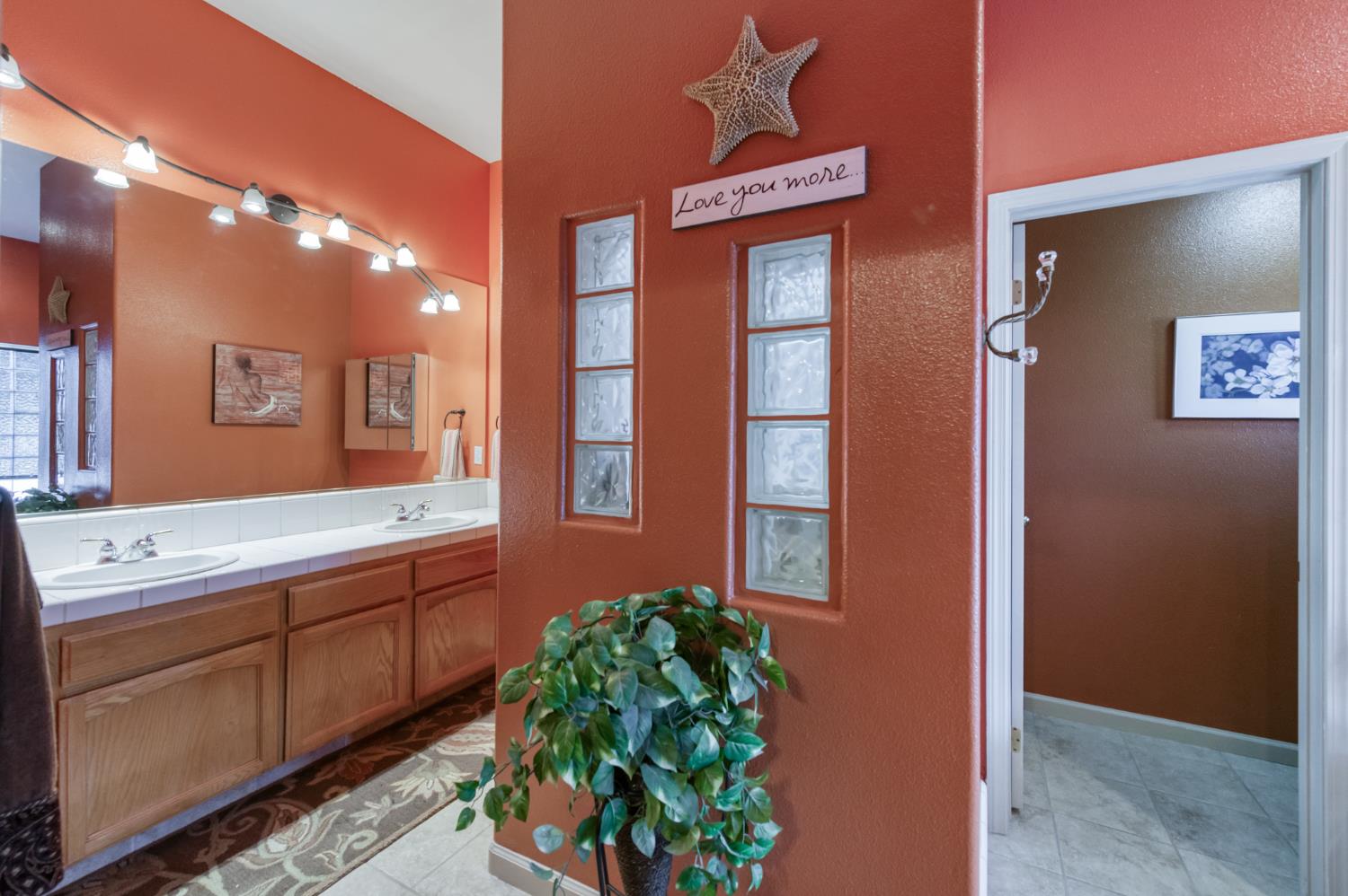 7360 Edgewater Street Chowchilla, CA 93610 - Photo 35 of 44 a bathroom with a sink a mirror and a shower