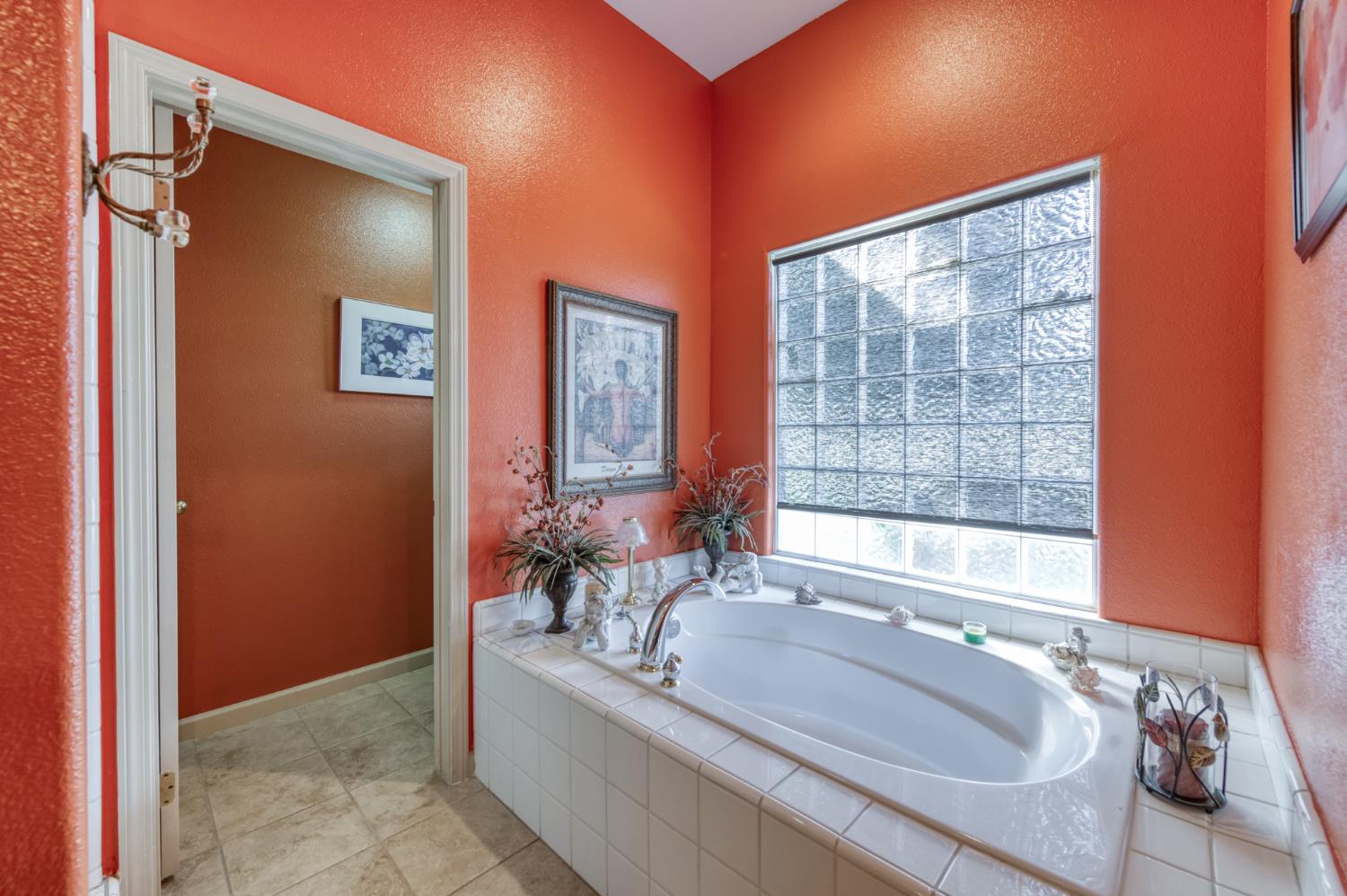 7360 Edgewater Street Chowchilla, CA 93610 - Photo 36 of 44 a bath tub sitting in a bathroom next to a window