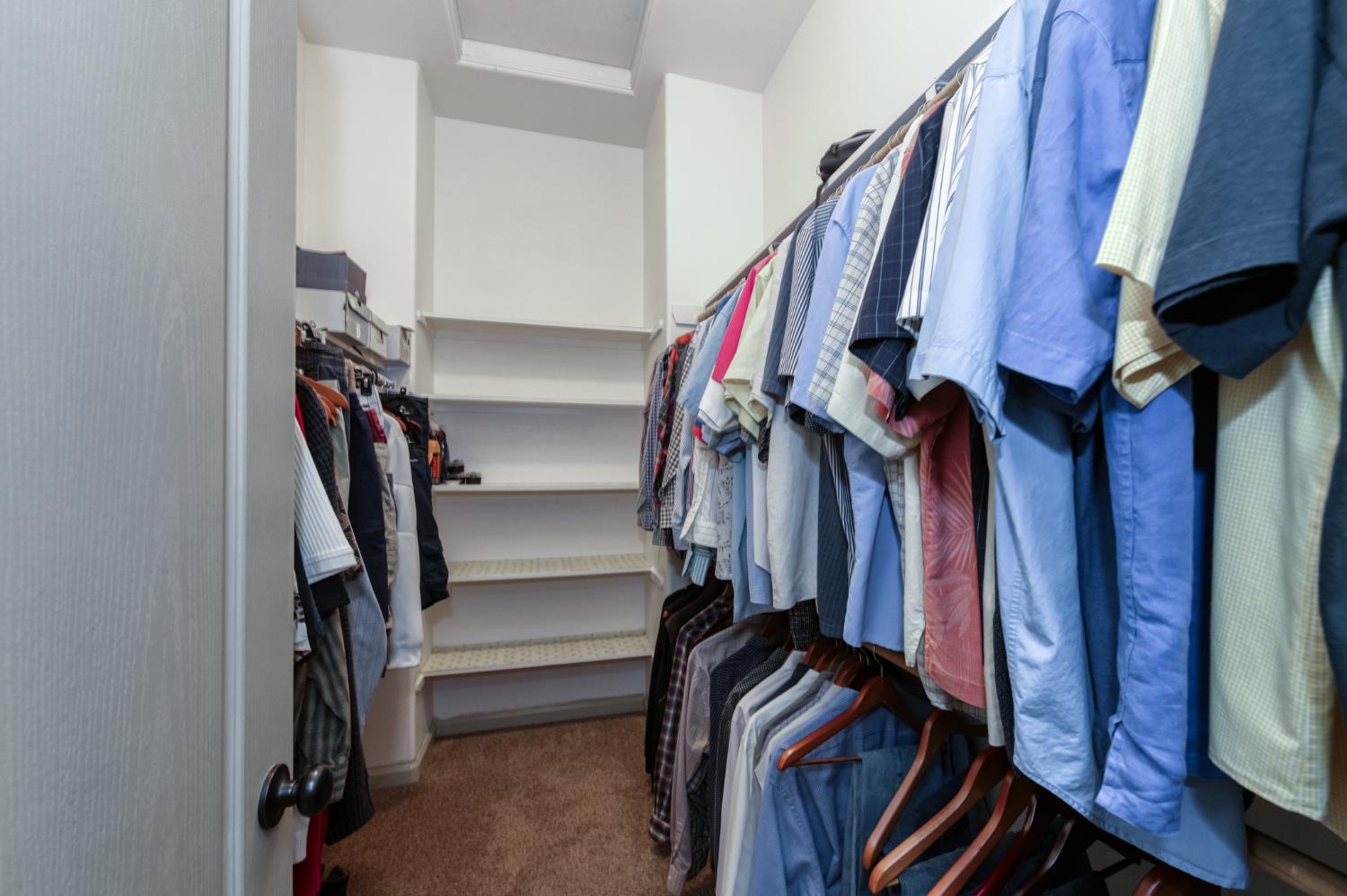 7360 Edgewater Street Chowchilla, CA 93610 - Photo 38 of 44 a view of walk in closet with clothes and shoes