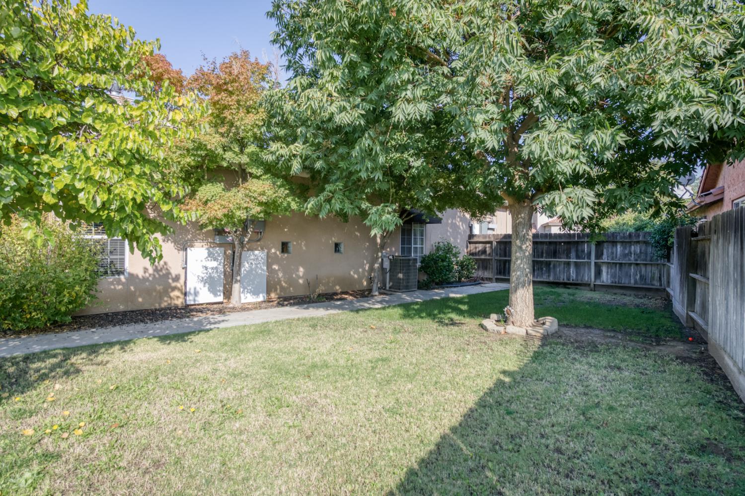 7360 Edgewater Street Chowchilla, CA 93610 - Photo 41 of 44 a view of a backyard with tree s