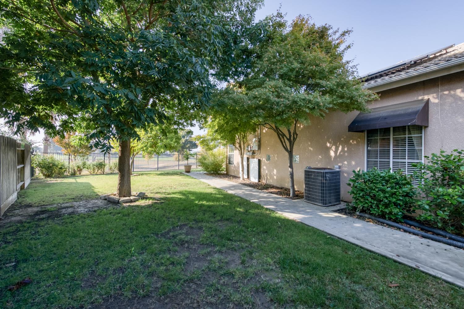 7360 Edgewater Street Chowchilla, CA 93610 - Photo 42 of 44 a view of a house with a yard