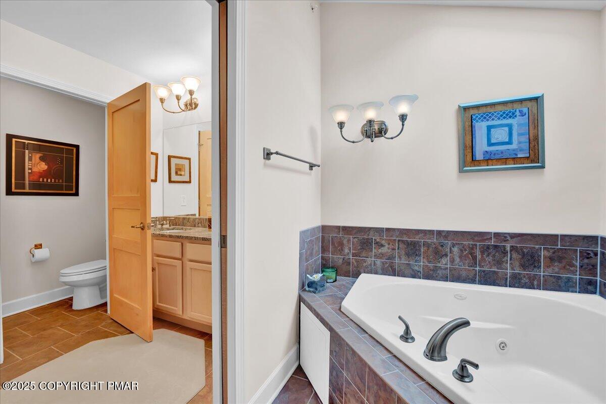 320 Hummingbird Way Lake, Unit 302J1 Lake Harmony, PA 18624 - Photo 11 of 29 a bathroom with a tub a toilet and a shower