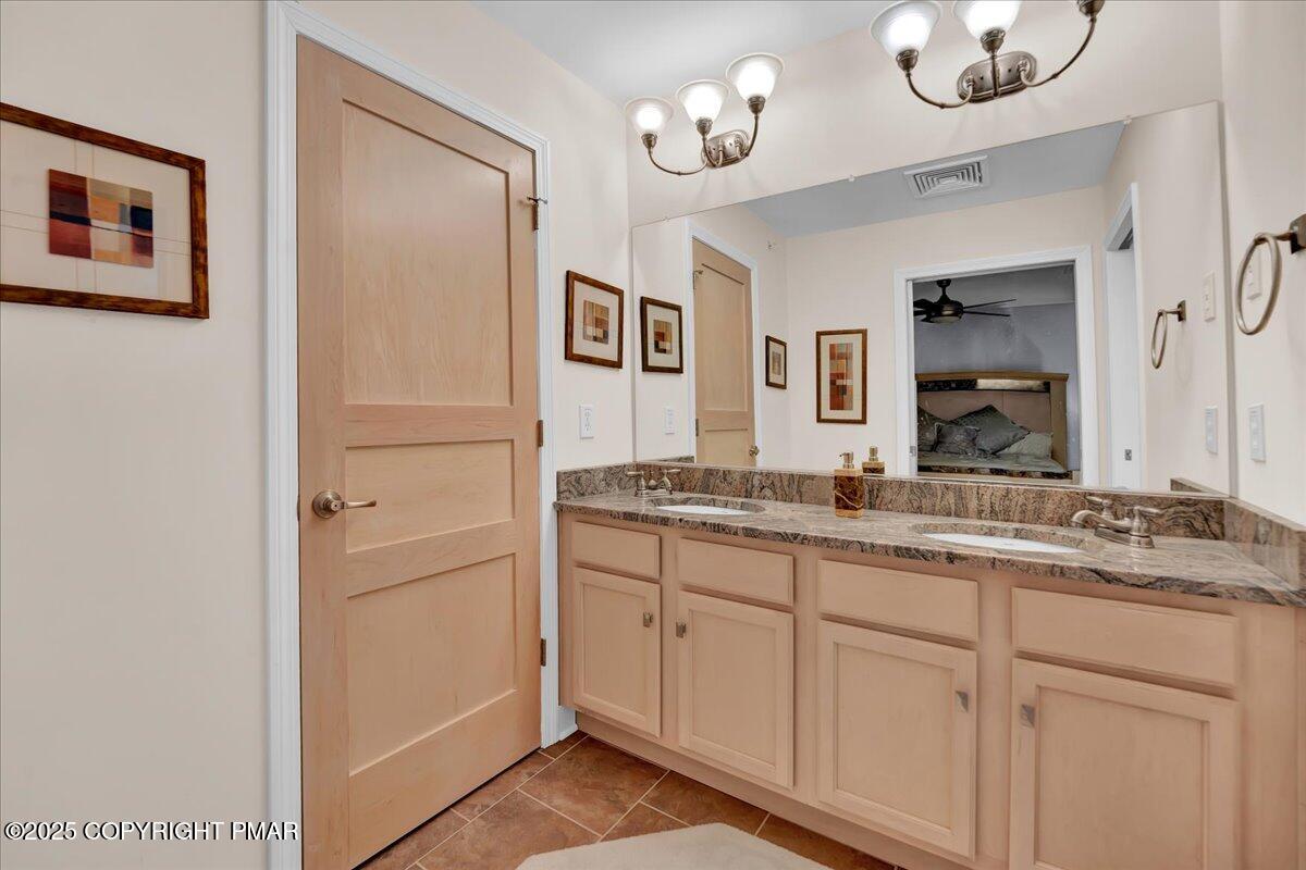 320 Hummingbird Way Lake, Unit 302J1 Lake Harmony, PA 18624 - Photo 12 of 29 a bathroom with a granite countertop sink mirror and vanity