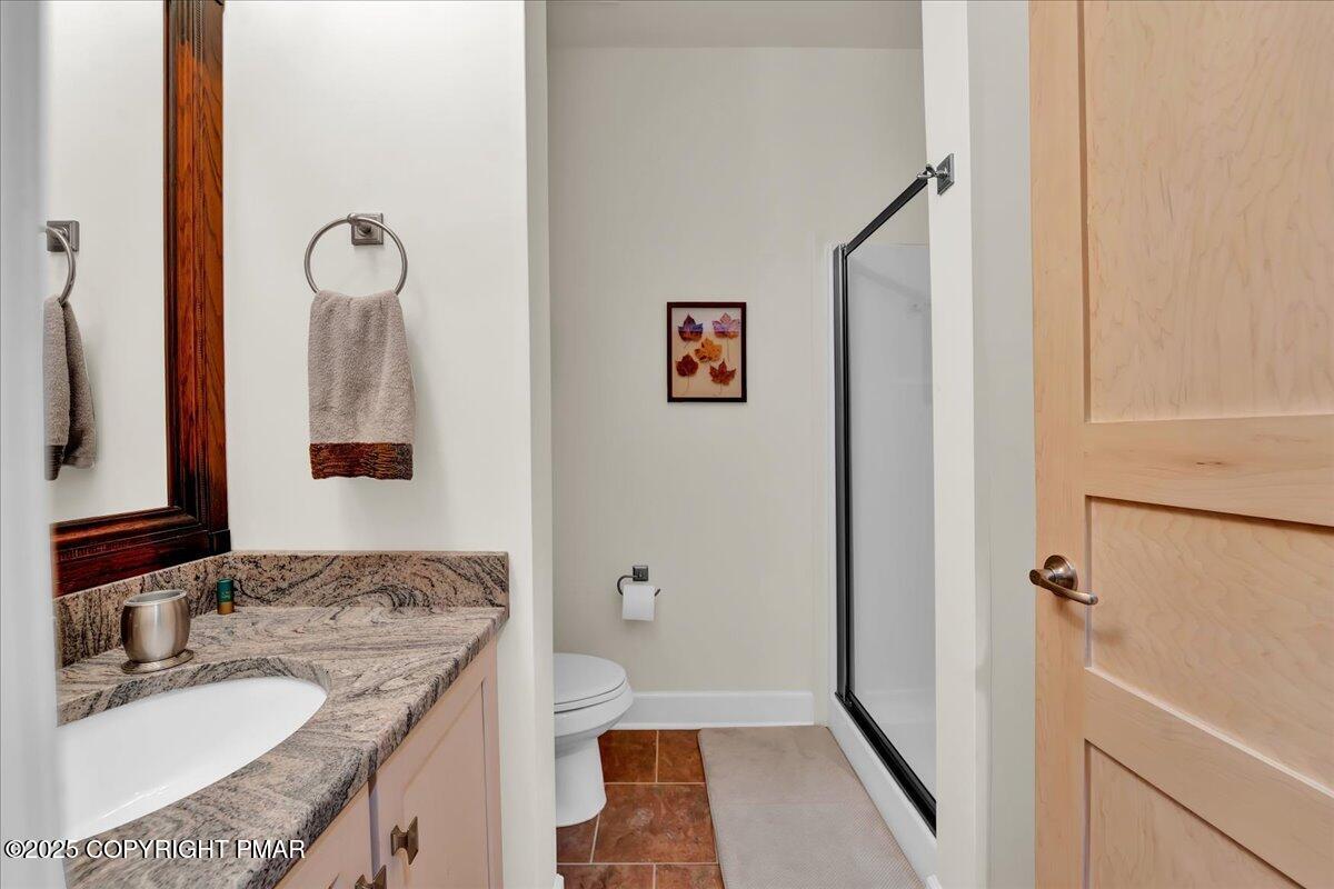 320 Hummingbird Way Lake, Unit 302J1 Lake Harmony, PA 18624 - Photo 14 of 29 a bathroom with a granite countertop sink a mirror and a shower