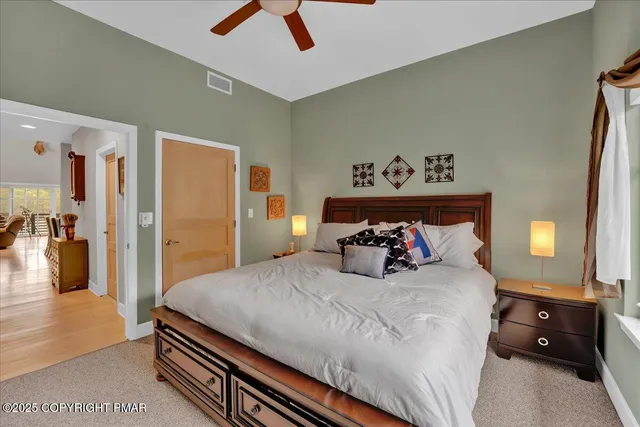 a bedroom with a bed and a large window