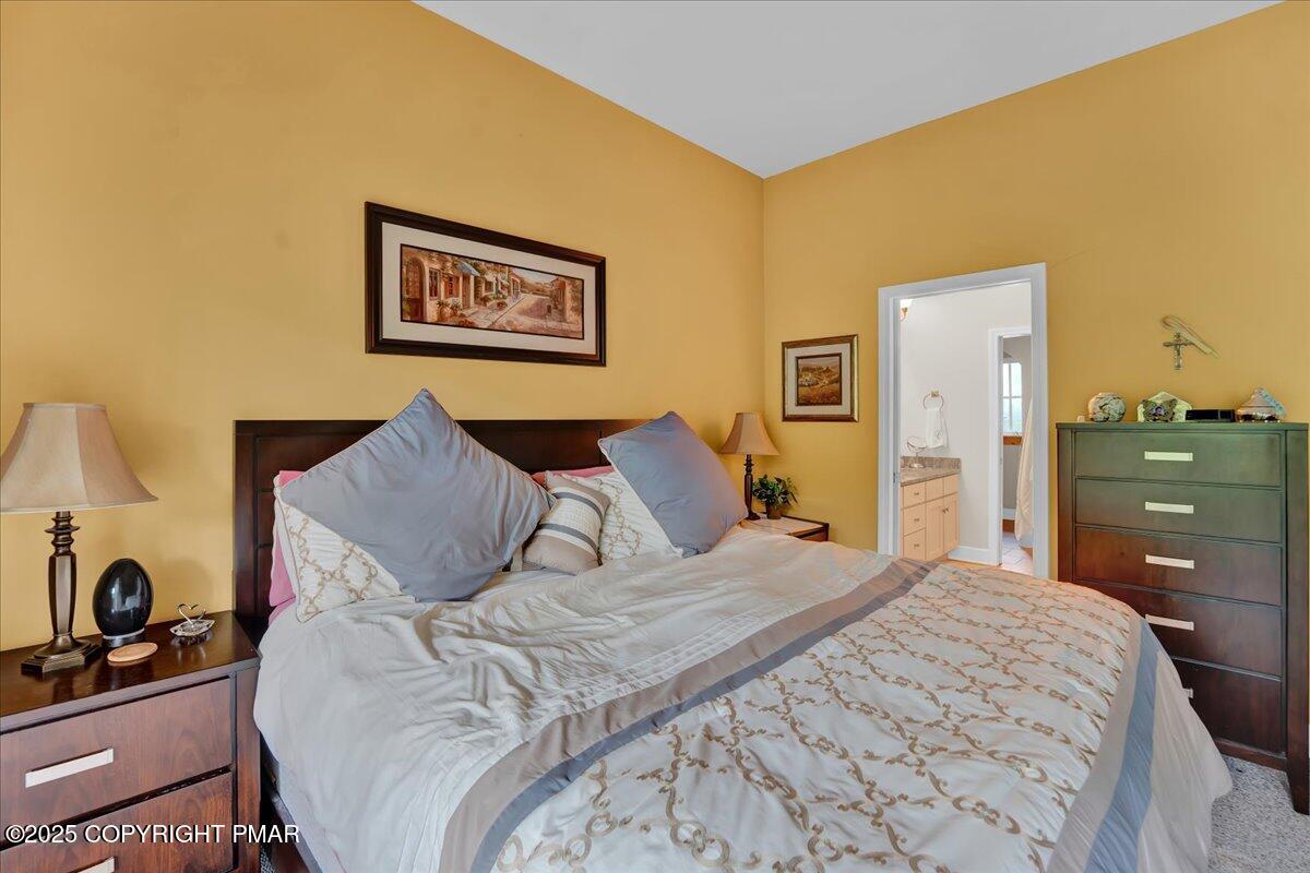 320 Hummingbird Way Lake, Unit 302J1 Lake Harmony, PA 18624 - Photo 18 of 29 a large bed sitting in a bedroom and dresser