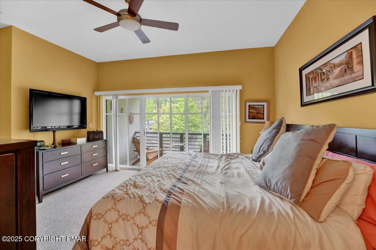320 Hummingbird Way Lake, Unit 302J1 Lake Harmony, PA 18624 - Photo 21 of 29 a bedroom with a bed and a flat screen tv