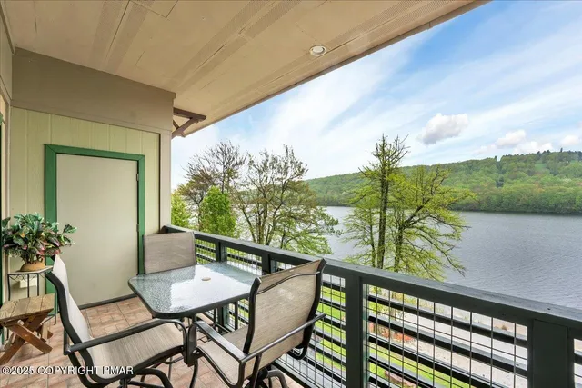 a view of a balcony with chairs and a table