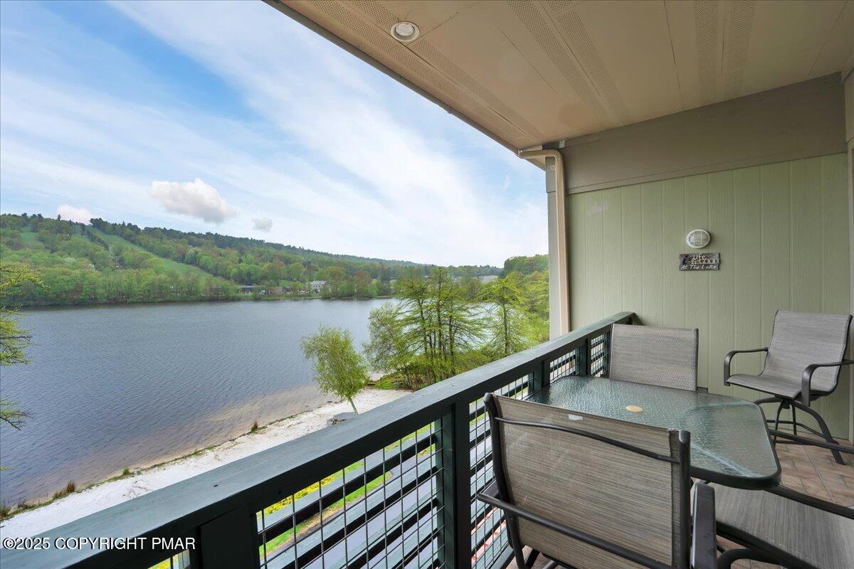 320 Hummingbird Way Lake, Unit 302J1 Lake Harmony, PA 18624 - Photo 24 of 29 a view of a balcony with chairs and a table