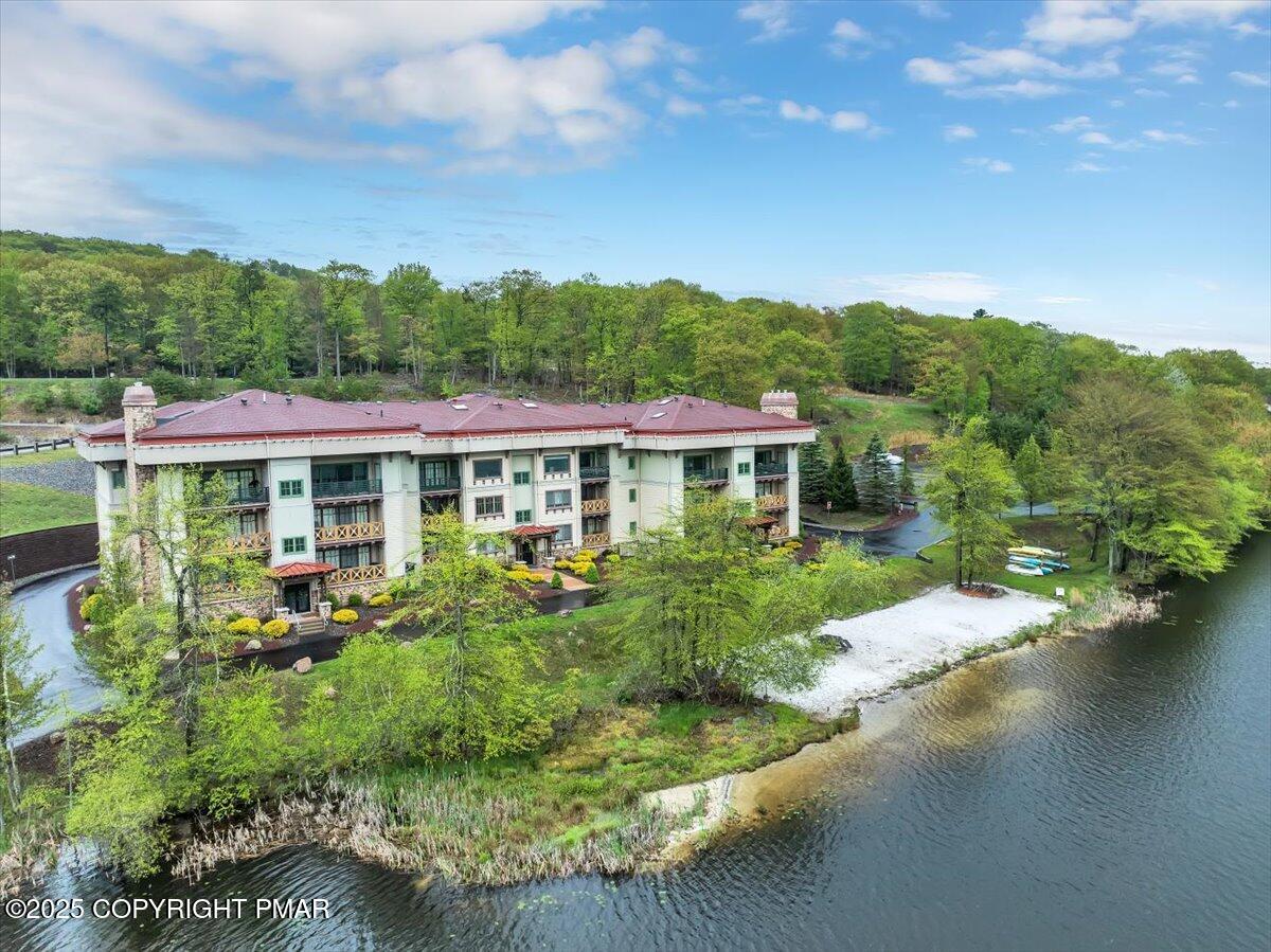 320 Hummingbird Way Lake, Unit 302J1 Lake Harmony, PA 18624 - Photo 27 of 29 a front view of a house with a yard table and chairs