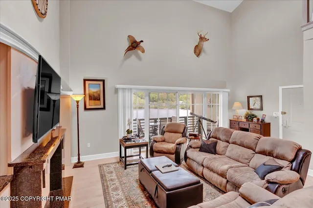 a living room with furniture a flat screen tv and a window