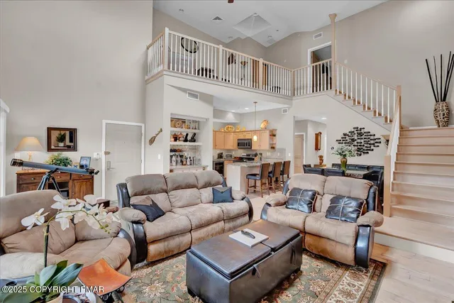 a living room with furniture a rug and a chandelier