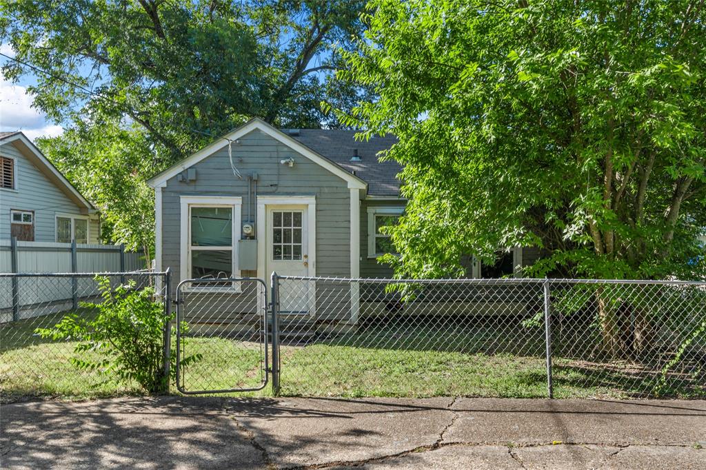 2225 Mitchell Avenue Waco, TX 76708 - Photo 14 of 16 Exterior featuring horizontal siding, a fenced yard, mature trees, and a gabled roofline