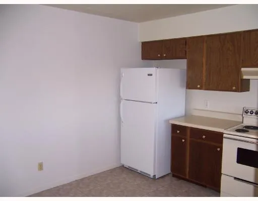 a kitchen with a refrigerator and cabinets