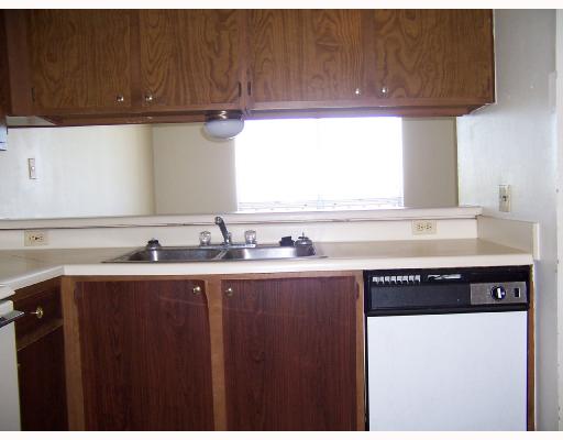 4502 Surfside Boulevard, Unit 8 Corpus Christi, TX 78402 - Photo 6 of 9 a kitchen with granite countertop a sink and a stove