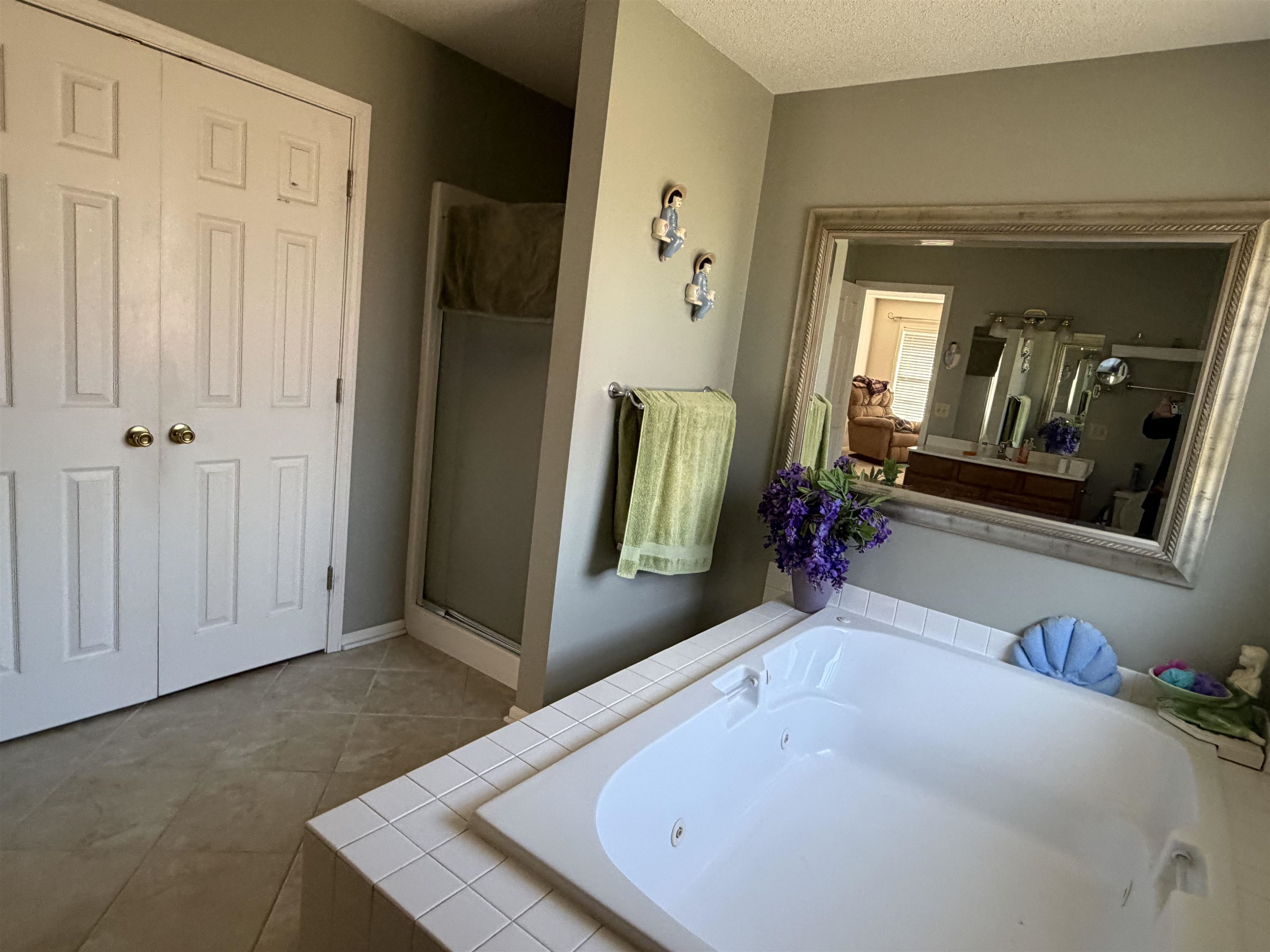 95 Lab Drive Buchanan, TN 38222 - Photo 12 of 19 Bathroom with a textured ceiling, a bath, a shower stall, and light tile patterned floors