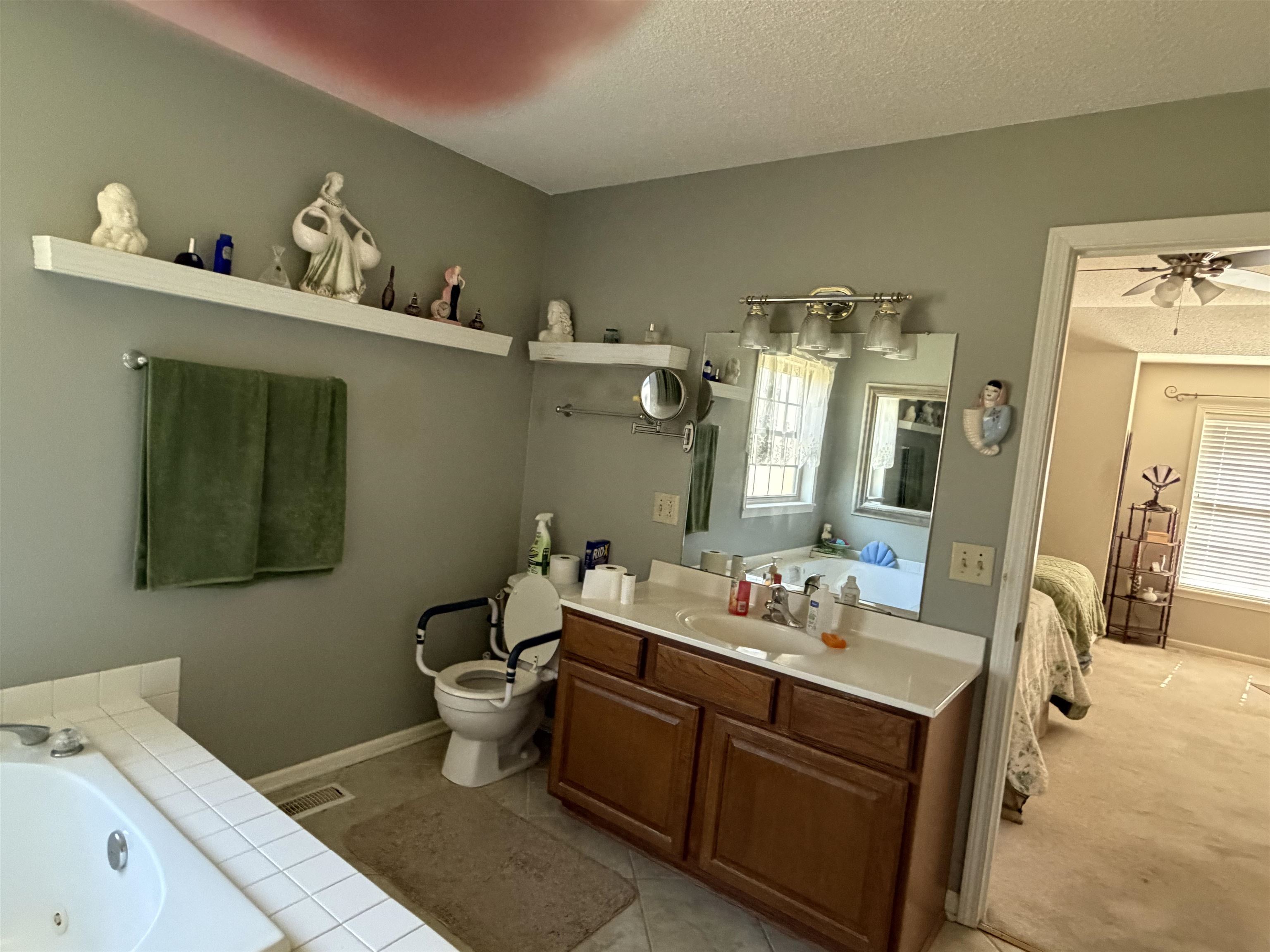 95 Lab Drive Buchanan, TN 38222 - Photo 13 of 19 Bathroom with a textured ceiling, ensuite bath, vanity, a ceiling fan, and a tub with jets