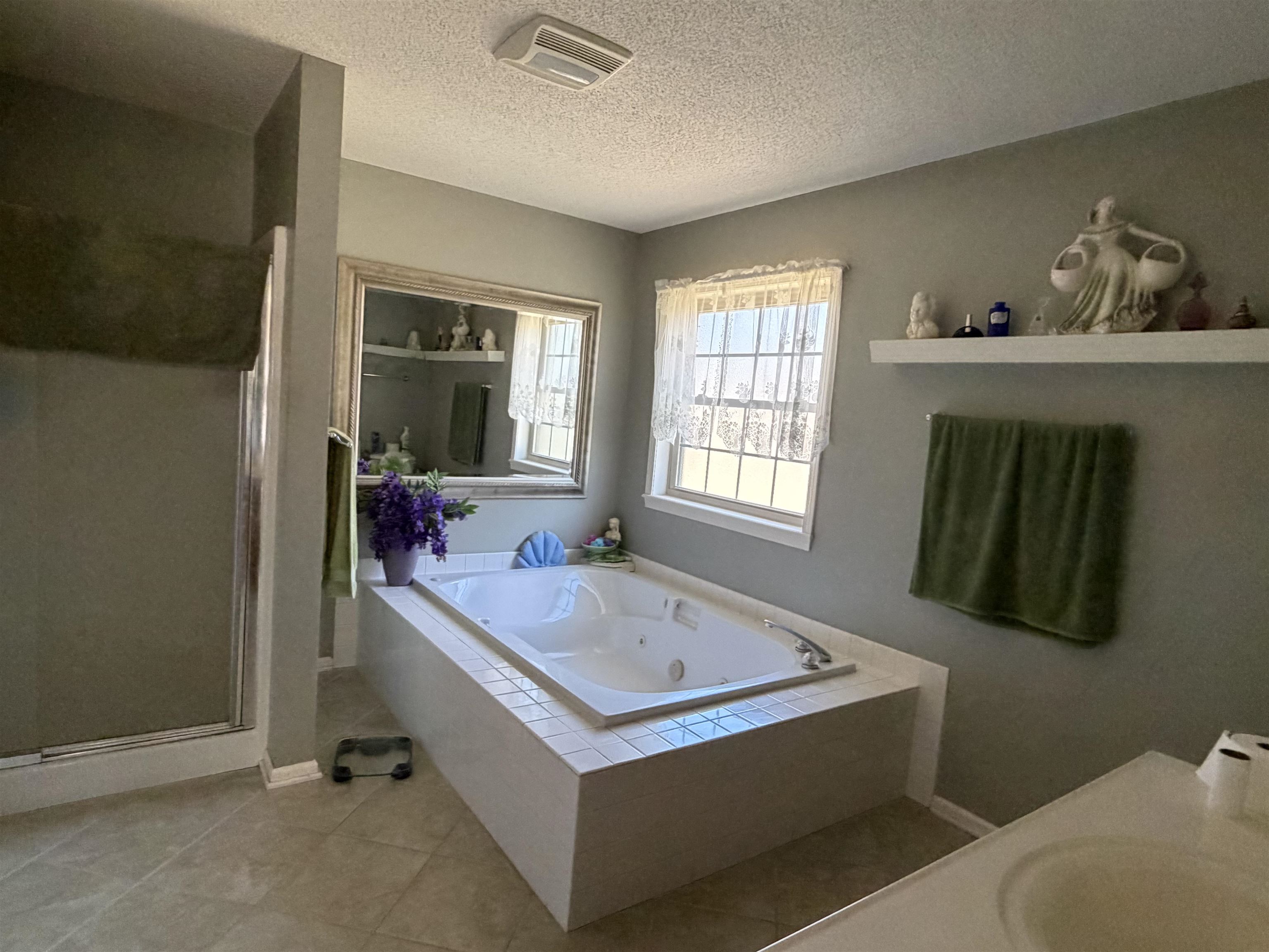 95 Lab Drive Buchanan, TN 38222 - Photo 14 of 19 Full bath with a stall shower, a tub with jets, a textured ceiling, vanity, and light tile patterned floors