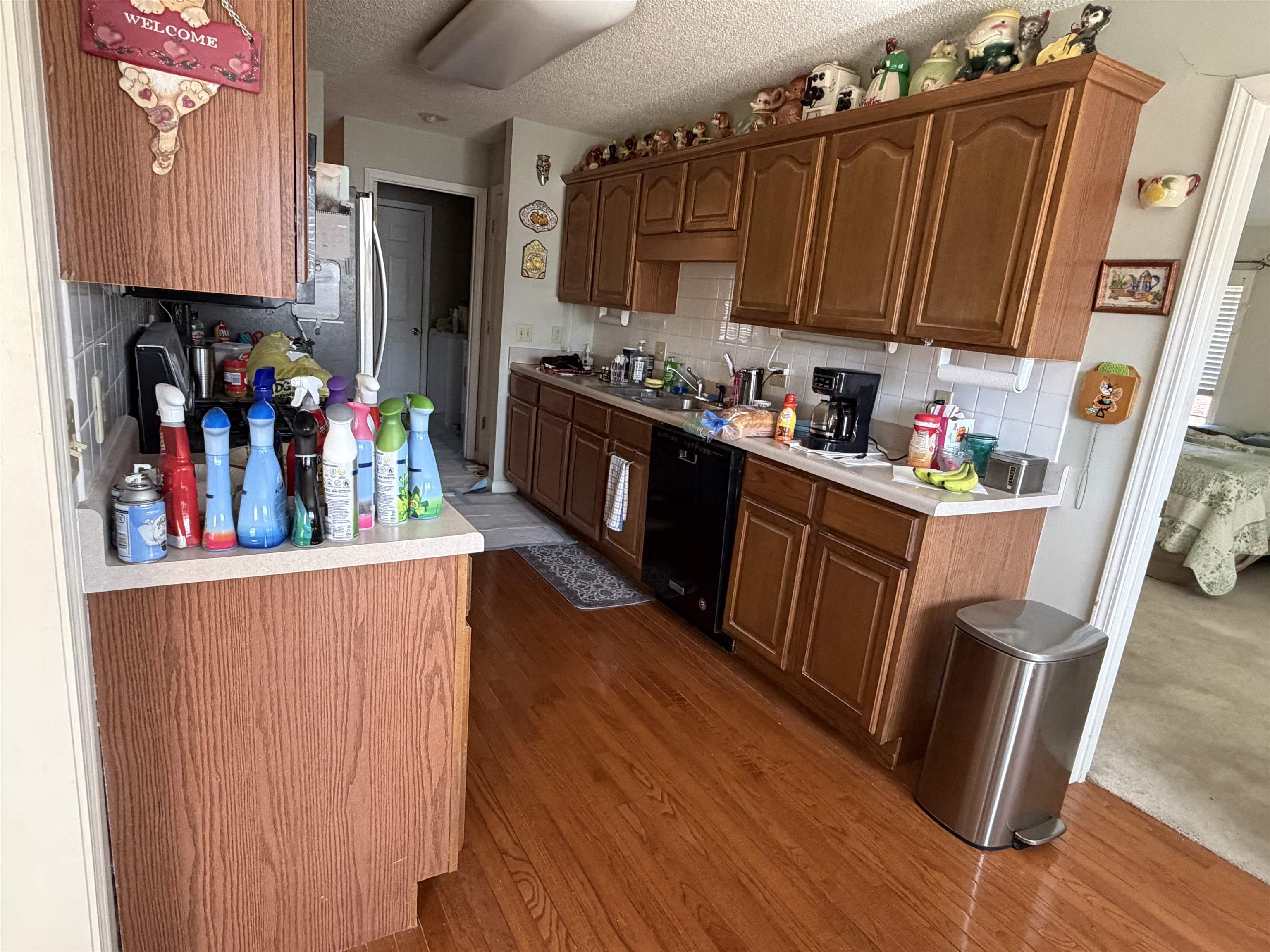 95 Lab Drive Buchanan, TN 38222 - Photo 17 of 19 Kitchen with light countertops, a textured ceiling, dishwasher, tasteful backsplash, and dark wood-style floors