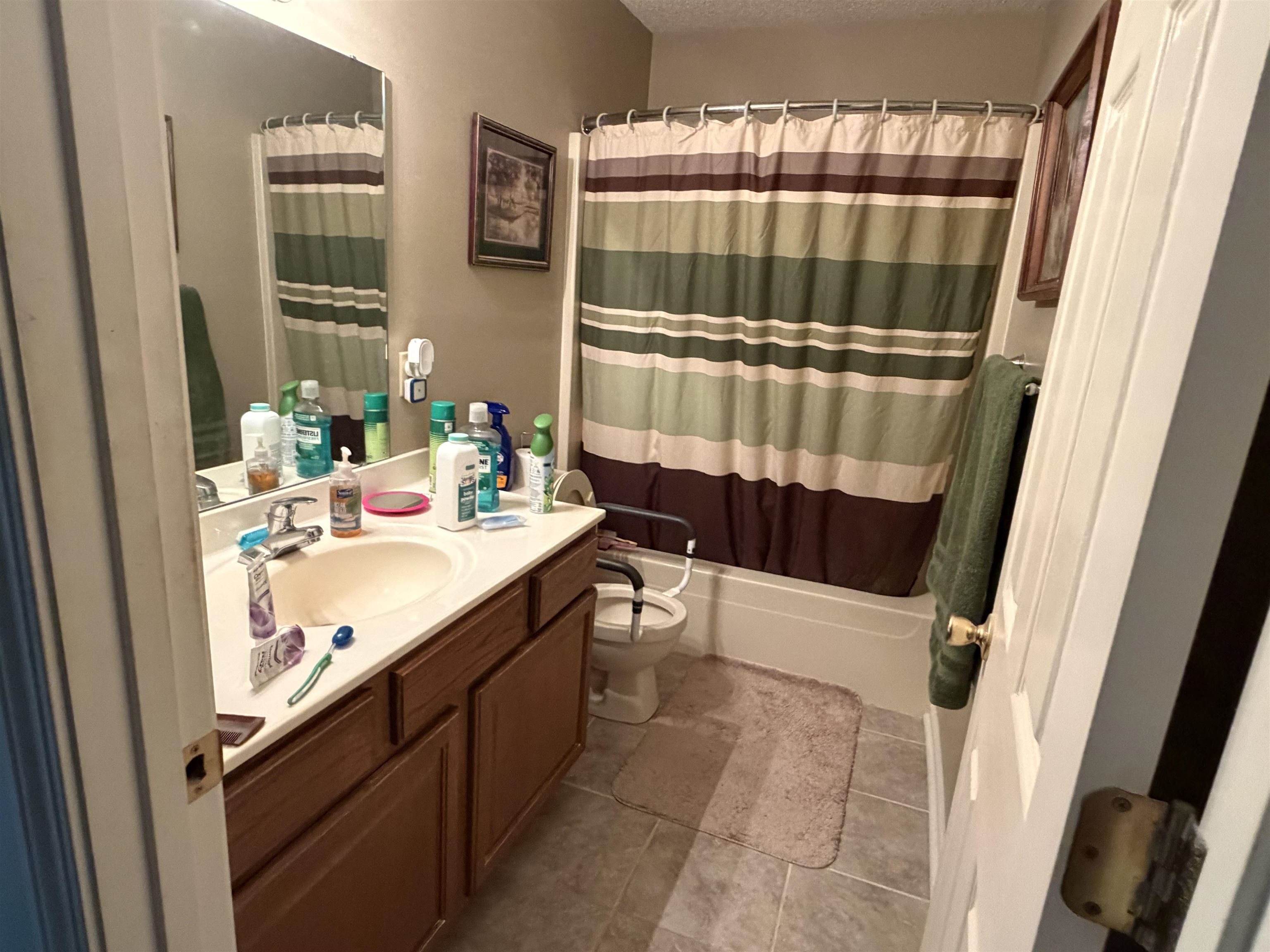 95 Lab Drive Buchanan, TN 38222 - Photo 9 of 19 Bathroom featuring vanity, shower / bath combination with curtain, a textured ceiling, and light tile patterned floors
