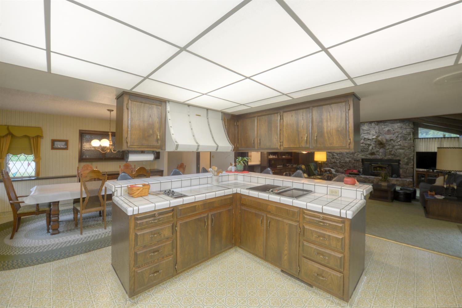 1471 Highway 33 Gustine, CA 95322 - Photo 14 of 57 a kitchen with a stove a sink a refrigerator and chairs