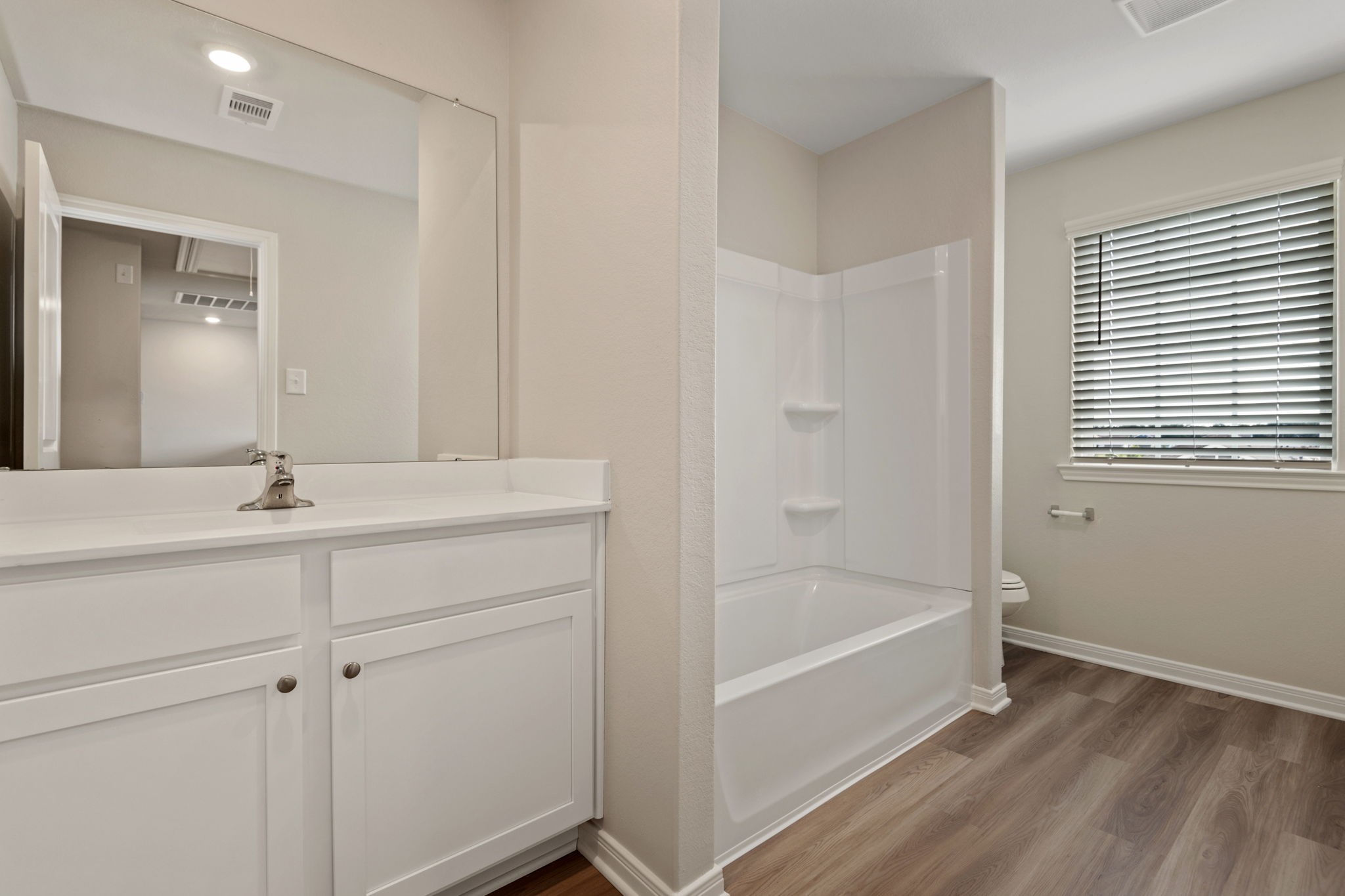 10339 Red Cardinal Drive Cleveland, TX 77328 - Photo 13 of 23 a bathroom with a bathtub and a sink