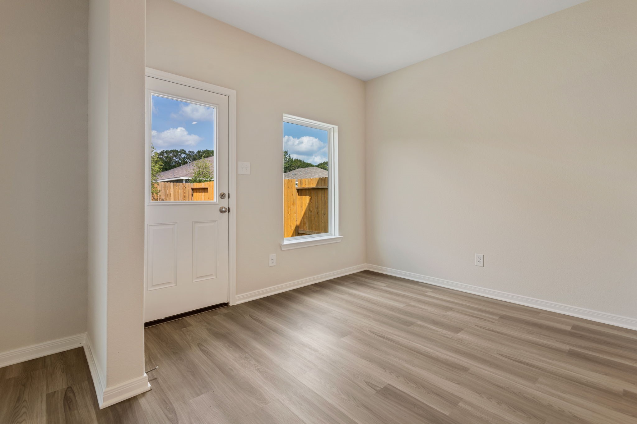 10339 Red Cardinal Drive Cleveland, TX 77328 - Photo 3 of 23 an empty room with wooden floor and windows