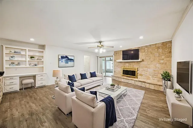 a living room with furniture a fireplace and a flat screen tv
