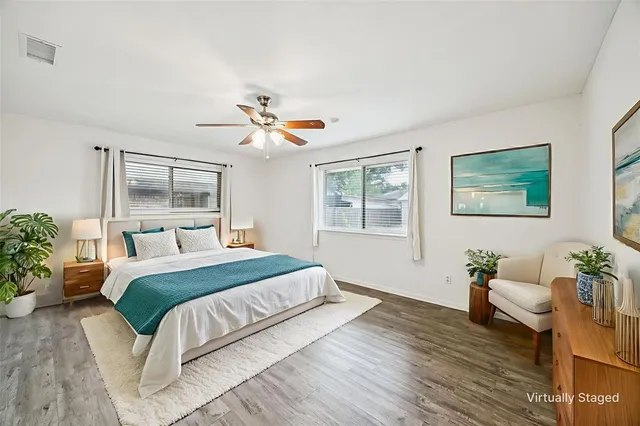 a bedroom with a large bed and a chandelier