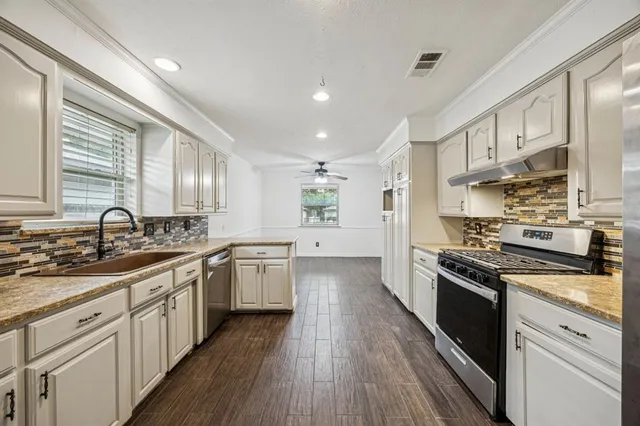 a large kitchen with a stove top oven