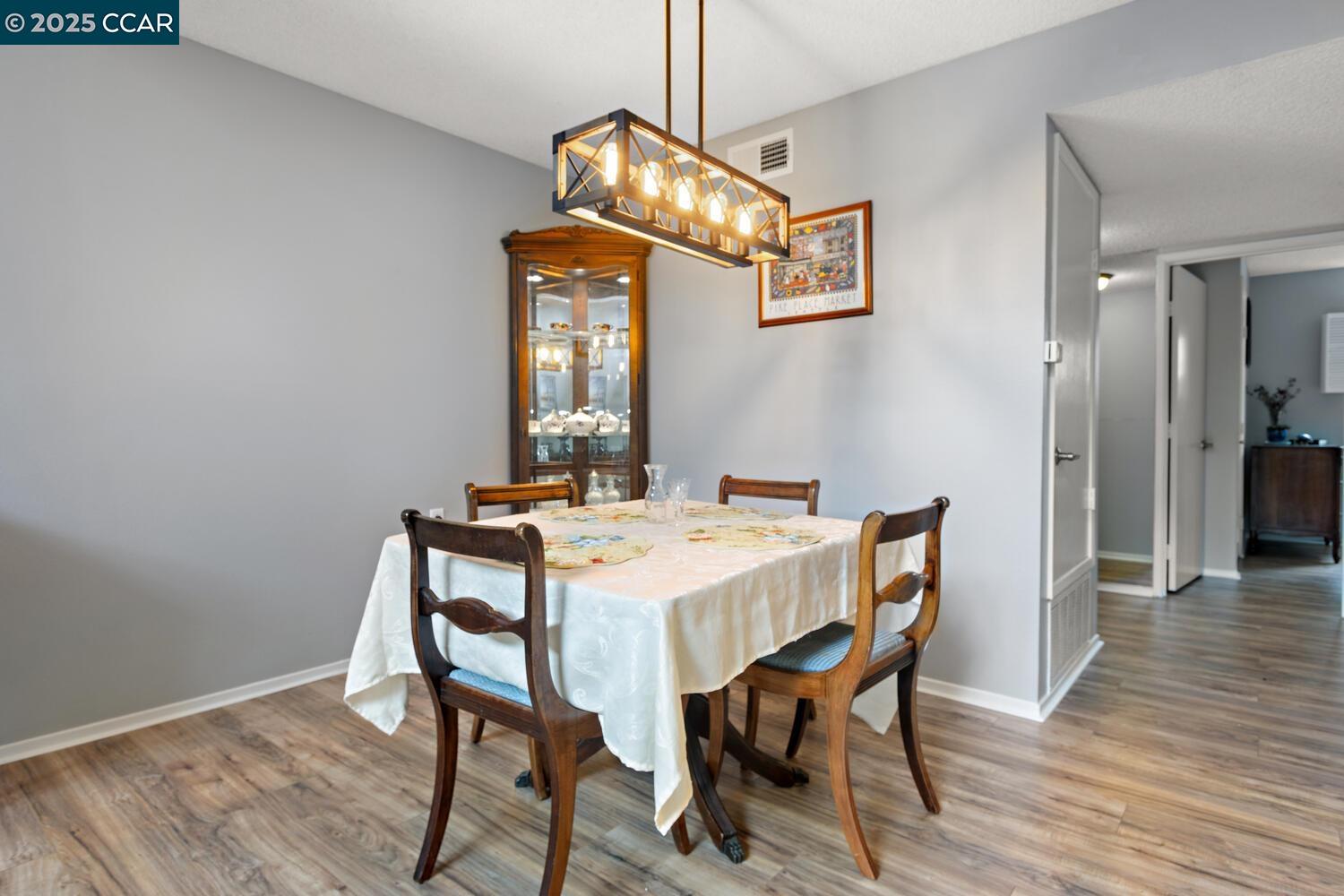 1244 Singingwood Court, Unit 1 Walnut Creek, CA 94595 - Photo 14 of 46 a view of a dining room with furniture and wooden floor