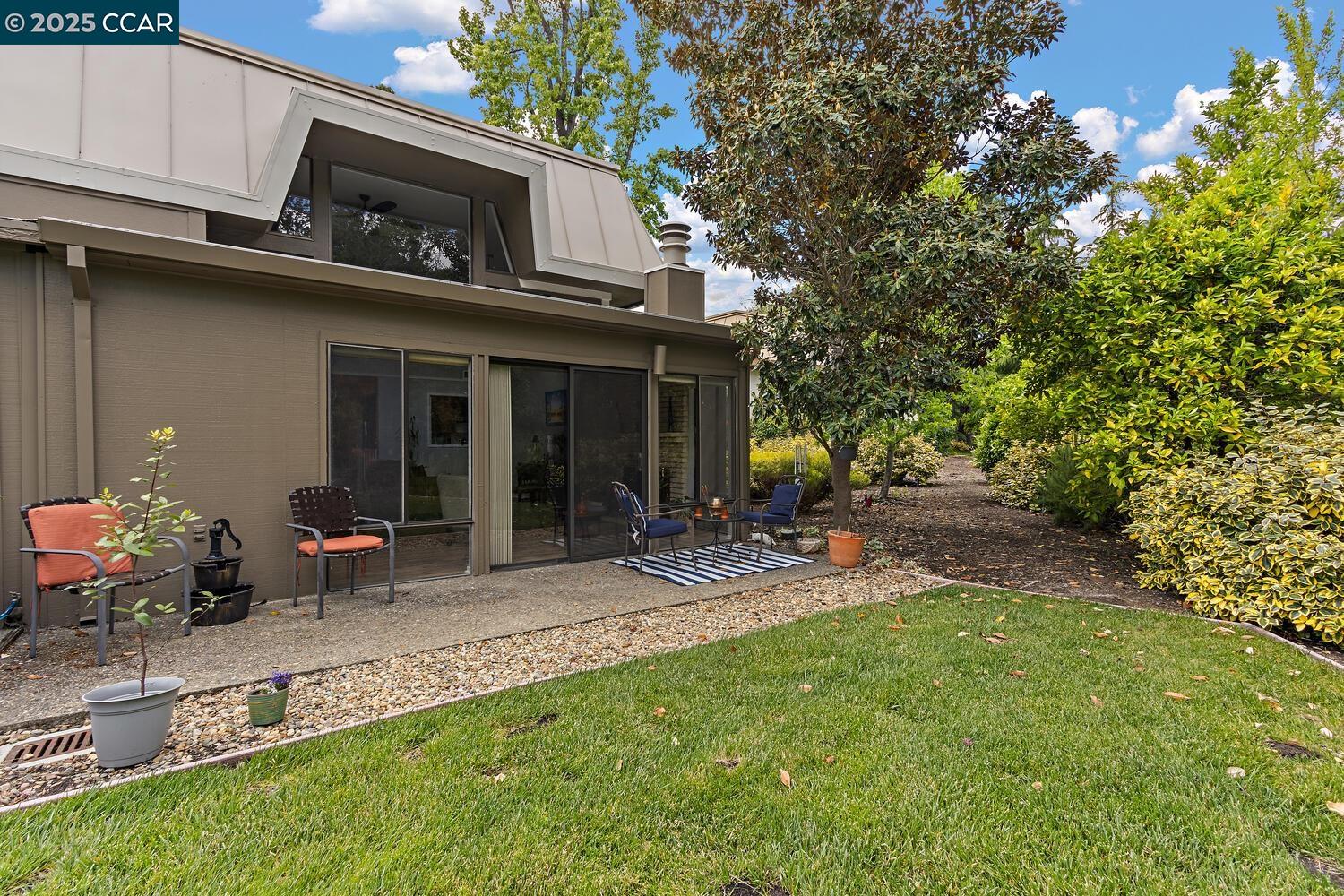 1244 Singingwood Court, Unit 1 Walnut Creek, CA 94595 - Photo 16 of 46 a view of a chair and table in backyard of the house
