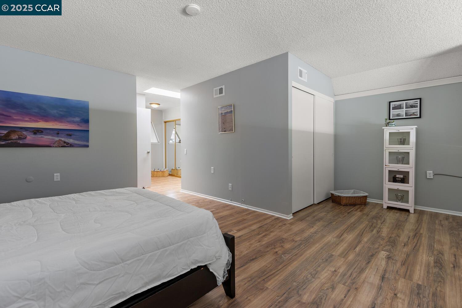 1244 Singingwood Court, Unit 1 Walnut Creek, CA 94595 - Photo 19 of 46 a bedroom with a bed and a window